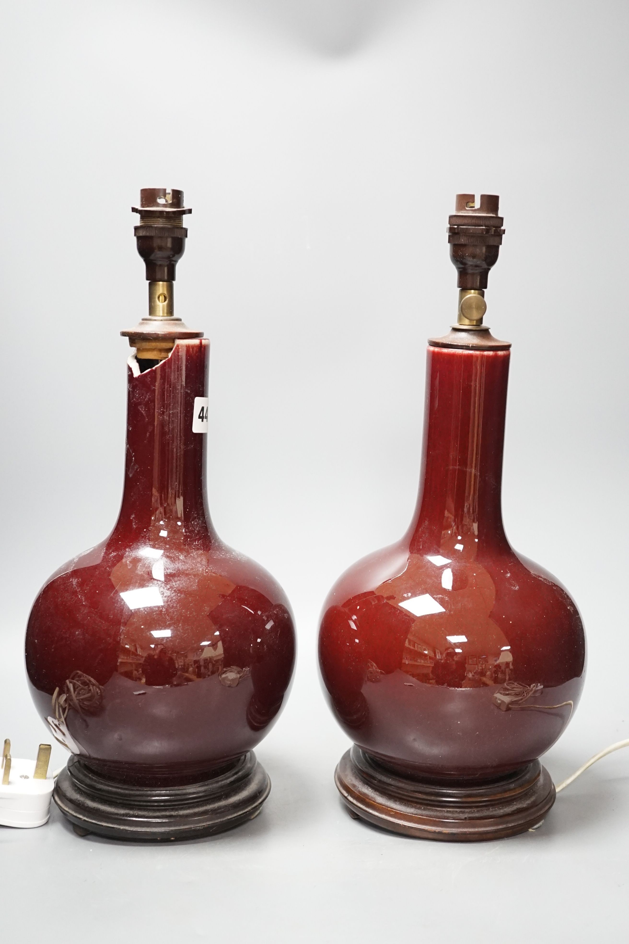 A pair of Chinese sang de boeuf glazed vases, converted to table lamps (a.f.)